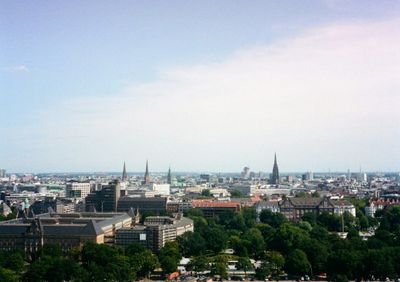 A lookout over the skyline of Hamburg. Several spires poke out admist the otherwise lowrise buildings.