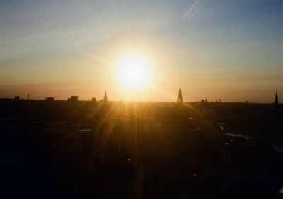 A view of the Copenhagen skyline at sunset, church spires rise up above the otherwise low-rised buildings.