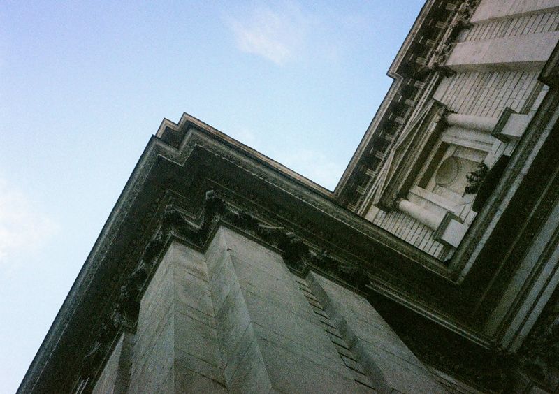 Stone walls turn at sharp angles in this picture. The view is looking up at the walls & sky.