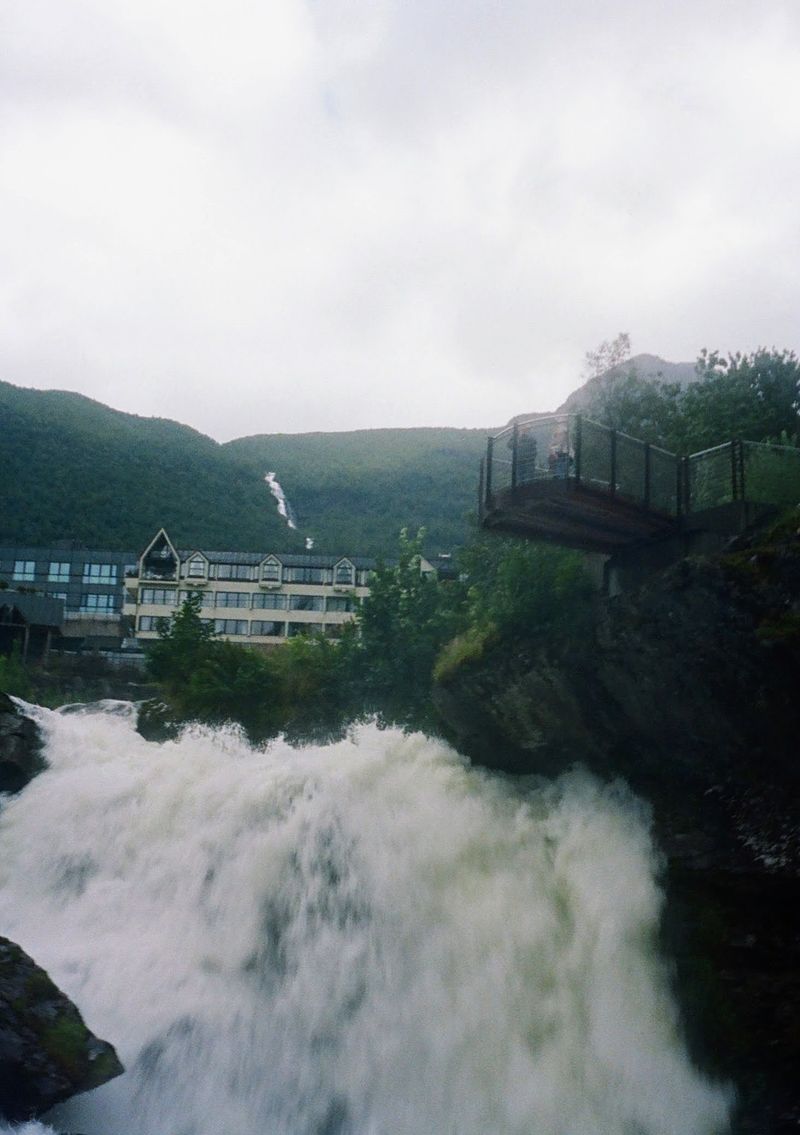 A waterfall crashes down beneath a viewing platform.